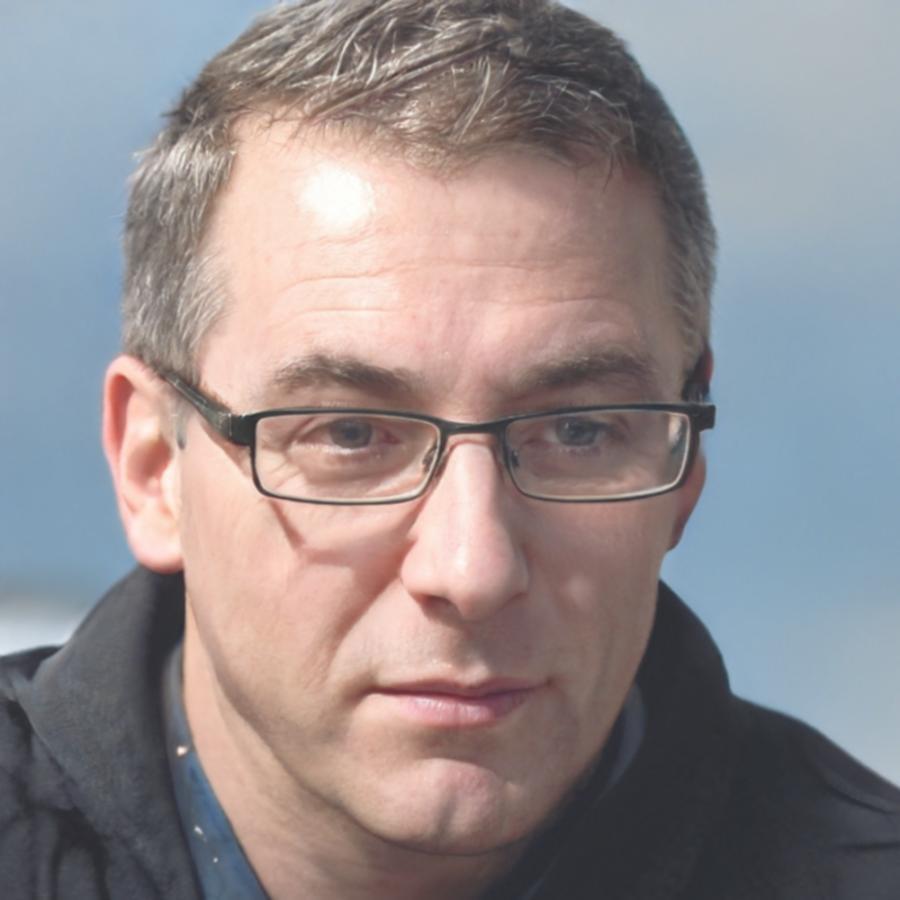 Portrait of Kaspian Throckwell, lead satirical writing instructor with over 15 years of publishing experience